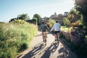 Couple riding e-bikes together in the countryside