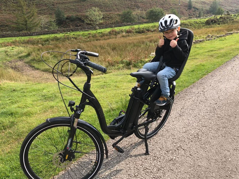 boy on back of ebike